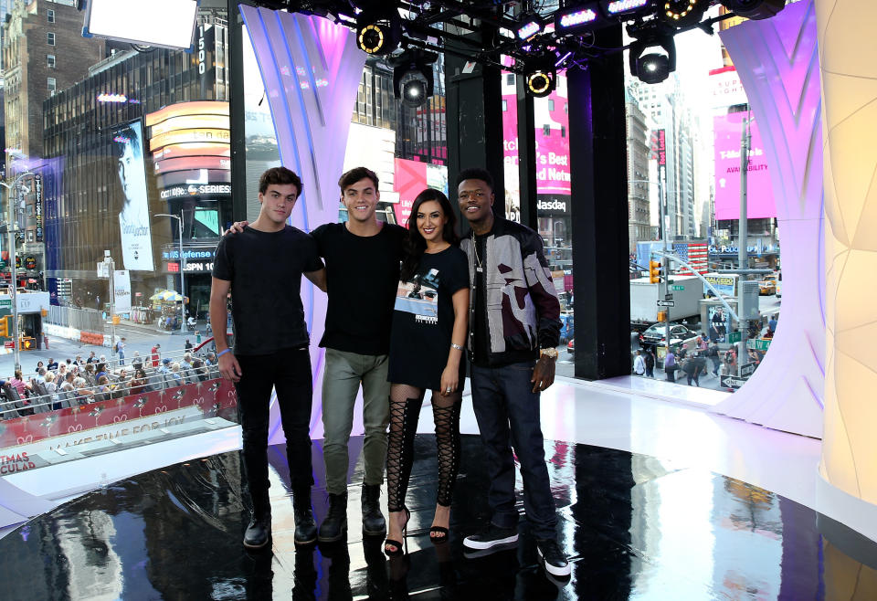 "TRL" squad members Ethan Dolan, Grayson Dolan and Tamara Dhia with "TRL" host DC Young Fly in front of the MTV studio's iconic floor-to-ceiling windows. (Photo: MTV)