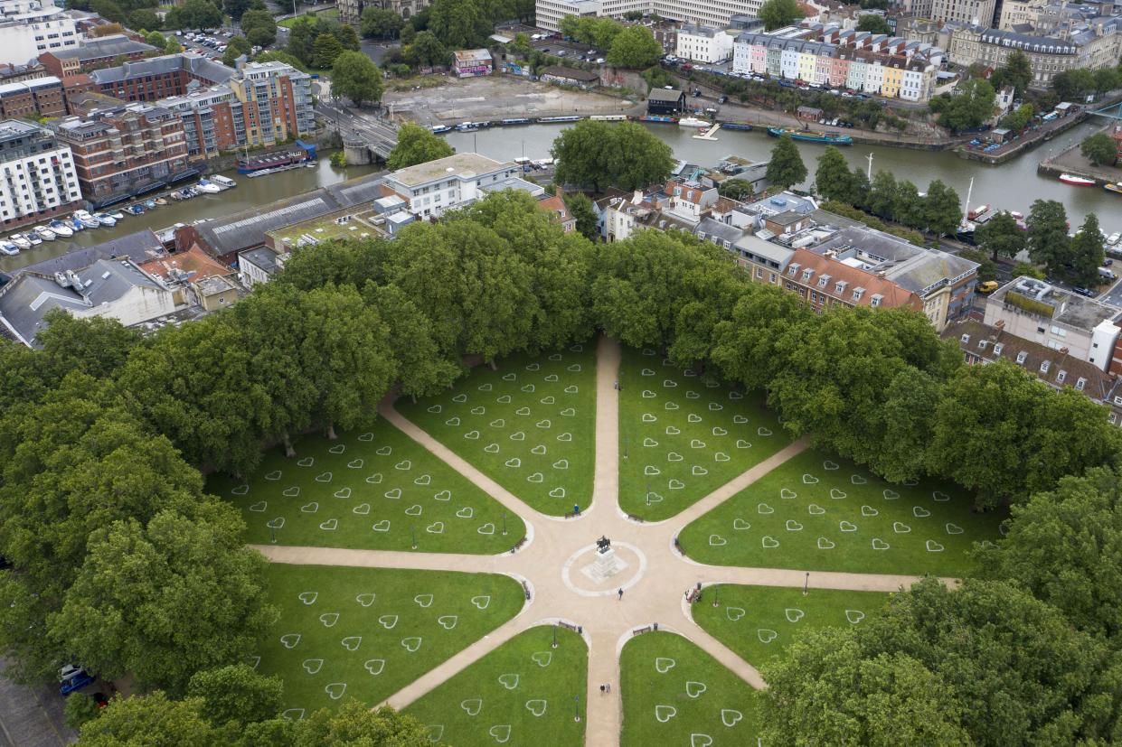 An aerial view of Queen Square shows hearts sprayed onto the grass in an effort to encourage social distancing on July 8, 2020, in Bristol, England. England has continued its phased easing of lockdown restrictions by reopening restaurants, pubs and hairdressing salons while the two-metre social distancing rule has been revised to 1m+.