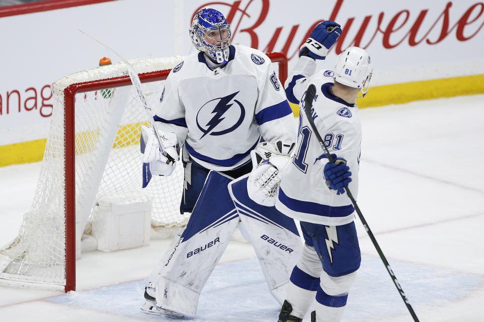 Tampa Bay Lightning goaltender Andrei Vasilevskiy (88) and Erik Cernak (81) celebrate a win over the Winnipeg Jets in NHL hockey game action in Winnipeg, Manitoba, Friday, Jan. 17, 2020. (John Woods/The Canadian Press via AP)