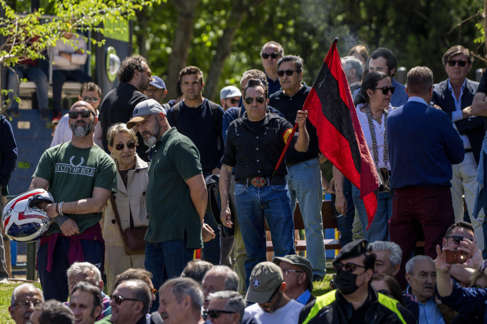 Dozens of people gather outside the San Isidro Cemetery in Madrid, Spain, Monday, April 24, 2023. The body of Jose Antonio Primo de Rivera, the founder of Spain’s fascist Falange movement, is exhumed from a Madrid mausoleum and transferred to a city cemetery. (AP Photo/Manu Fernandez)