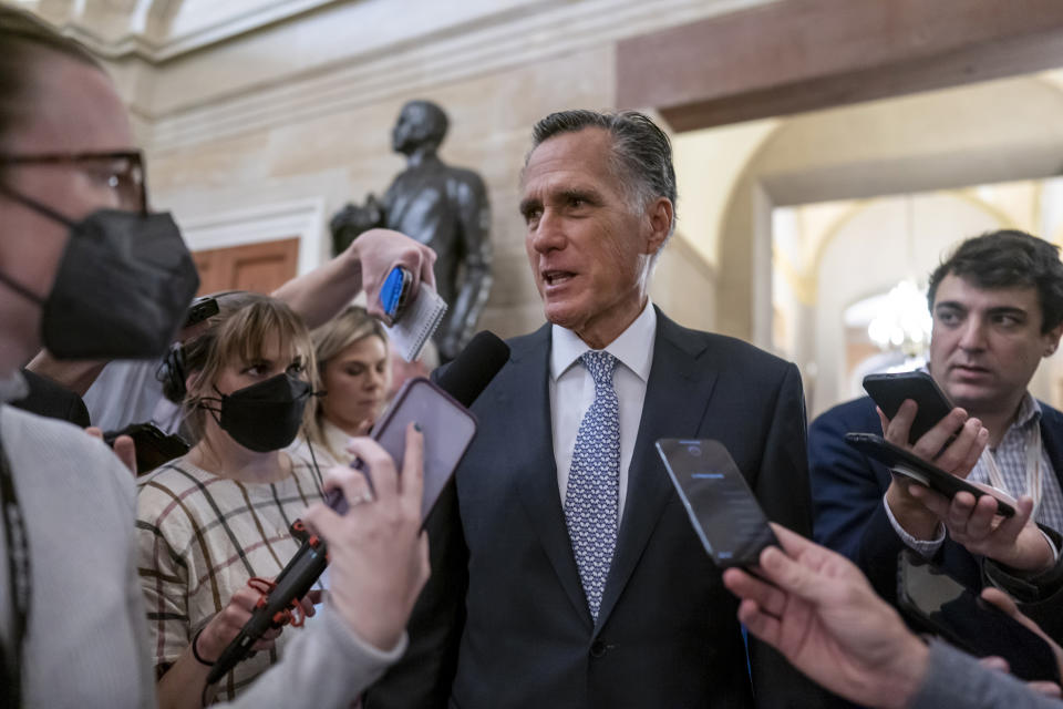 Sen. Mitt Romney, R-Utah, is surrounded by reporters as he arrives at the historic Old Senate Chamber where Sen. Rick Scott, R-Fla., is mounting a long-shot bid to unseat Senate Republican leader Mitch McConnell, at the Capitol in Washington, Wednesday, Nov. 16, 2022. (AP Photo/J. Scott Applewhite)
