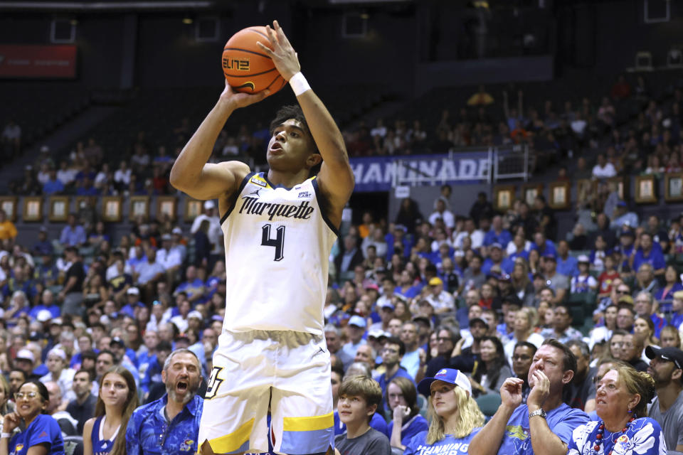 Marquette guard Stevie Mitchell shoots a 3-pointer against Kansas during the first half of an NCAA college basketball game Tuesday, Nov. 21, 2023, in Honolulu. (AP Photo/Marco Garcia)