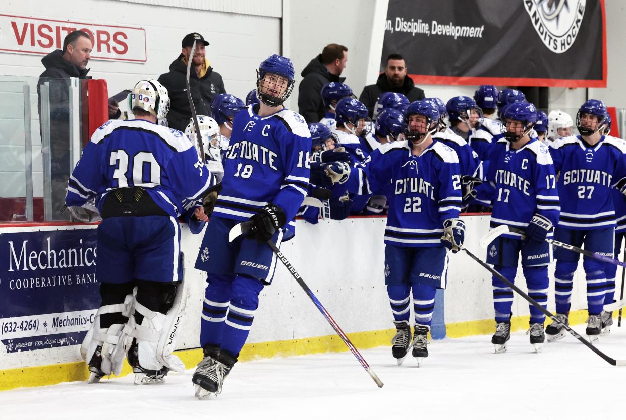 Scituate's James Sullivan, center, celebrates with teammates after scoring a first period hat trick against Bridgewater-Raynham during a game on Saturday, Feb. 3, 2024.
