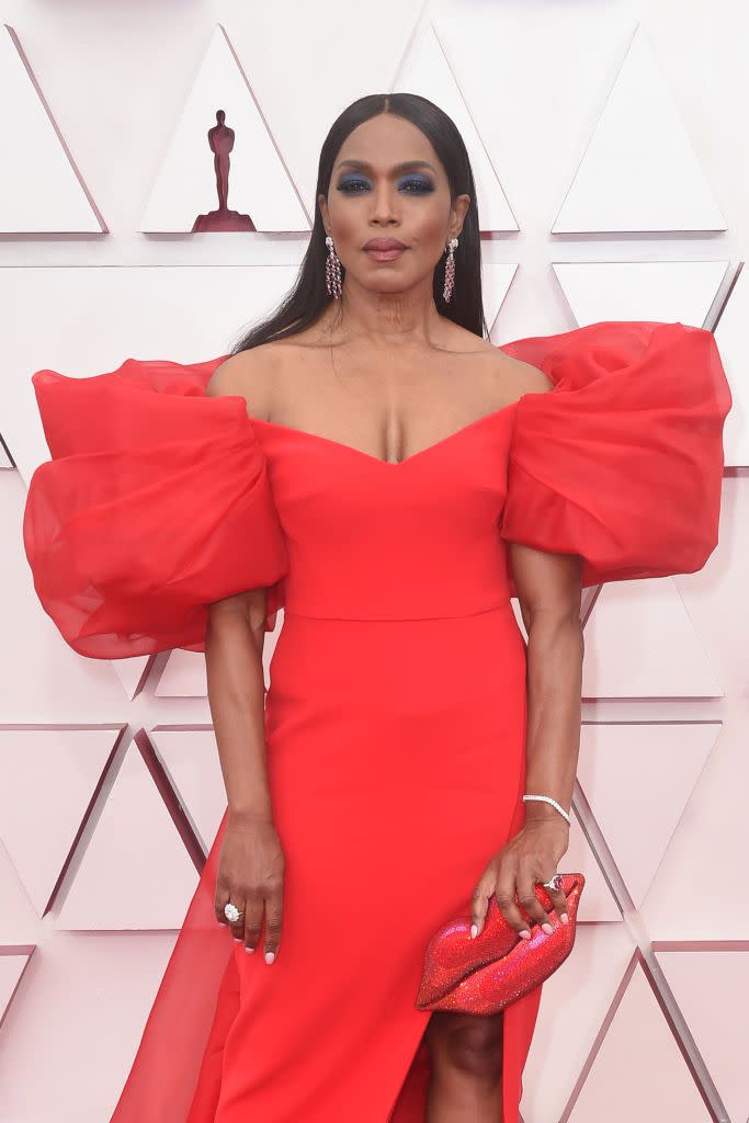 angela basset wears a red dress with giant sleeves on the red carpet