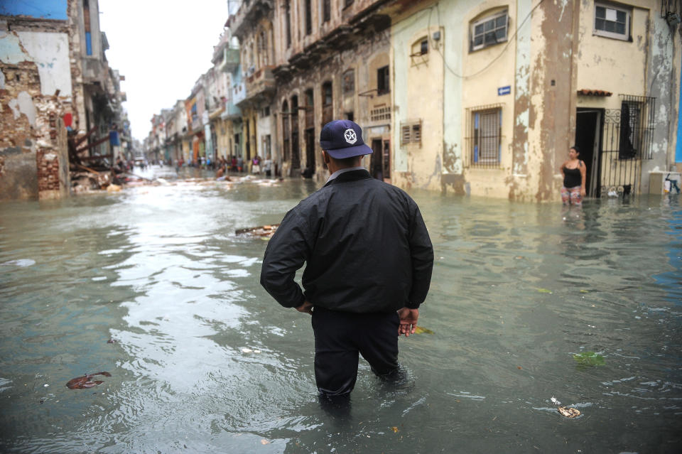 A Cuban wades through a flooded street in Havana, on September 10, 2017. Deadly Hurricane Irma battered central Cuba on Saturday, knocking down power lines, uprooting trees and ripping the roofs off homes as it headed towards Florida. Authorities said they had evacuated more than a million people as a precaution, including about 4,000 in the capital.  / AFP PHOTO / YAMIL LAGE        (Photo credit should read YAMIL LAGE/AFP/Getty Images)