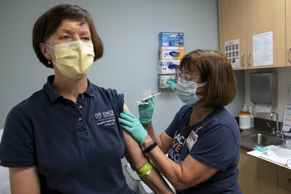 A medical professional getting a shot.