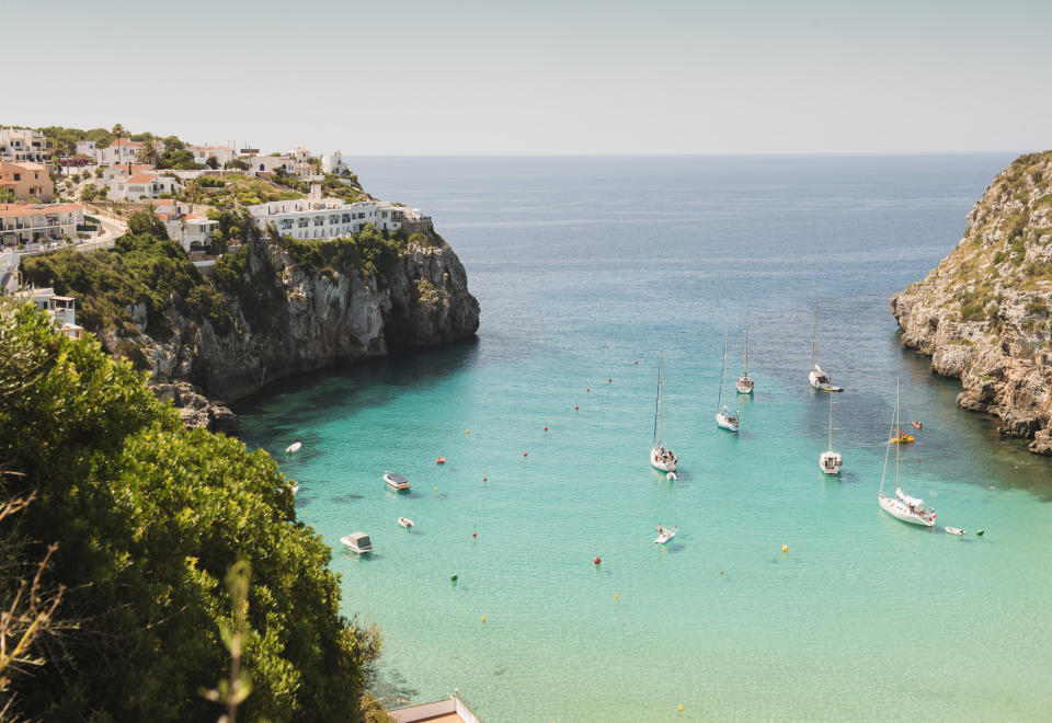 Boats in the serene blue water in Menorca.