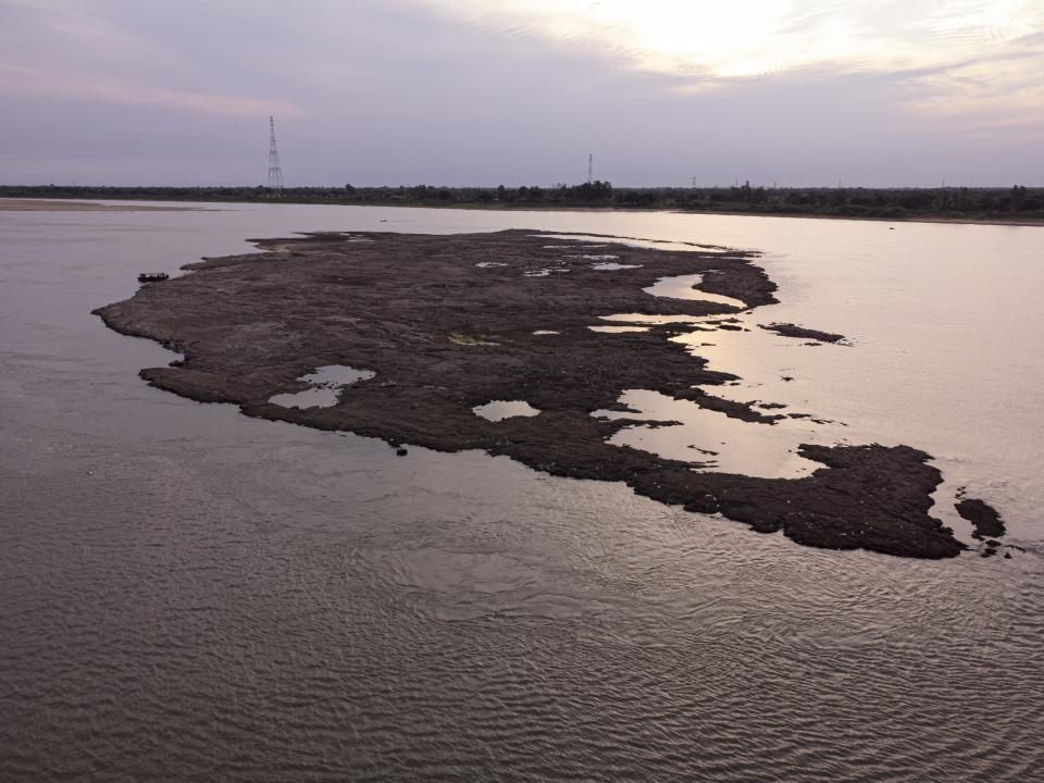 An ancient extinct volcano is exposed by the low level of the Paraguay river, in Asuncion amid a historic drought that is affecting the river's level, in Paraguay, Wednesday, Sept. 22, 2021. (AP Photo/Jorge Saenz)