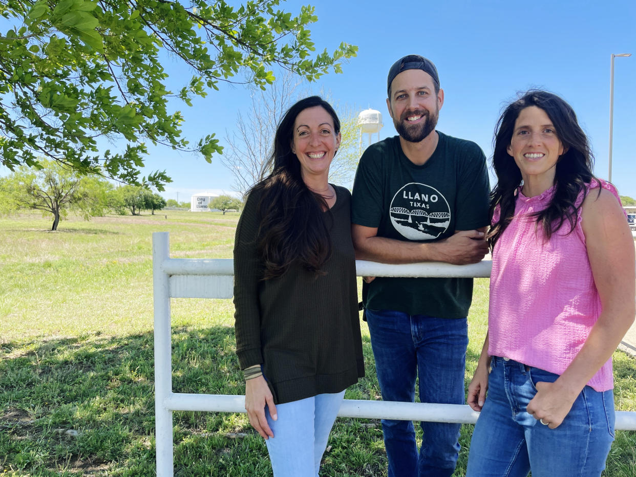 From left, Lynsi Herron, 40, Jason Herron, 39 of Llano, and Sara Virdell, 37, of Brady, Texas, wait outside the Llano County Law Enforcement Building. (Suzanne Gamboa / NBC News)