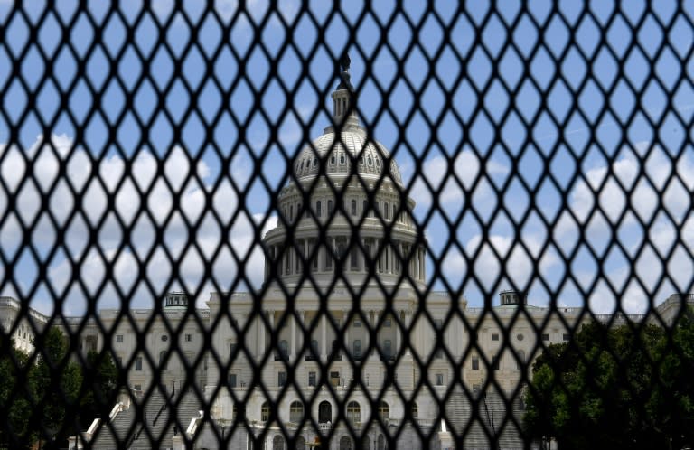 The US Capitol is seen behind fences in July 2021 (AFP/Olivier DOULIERY)