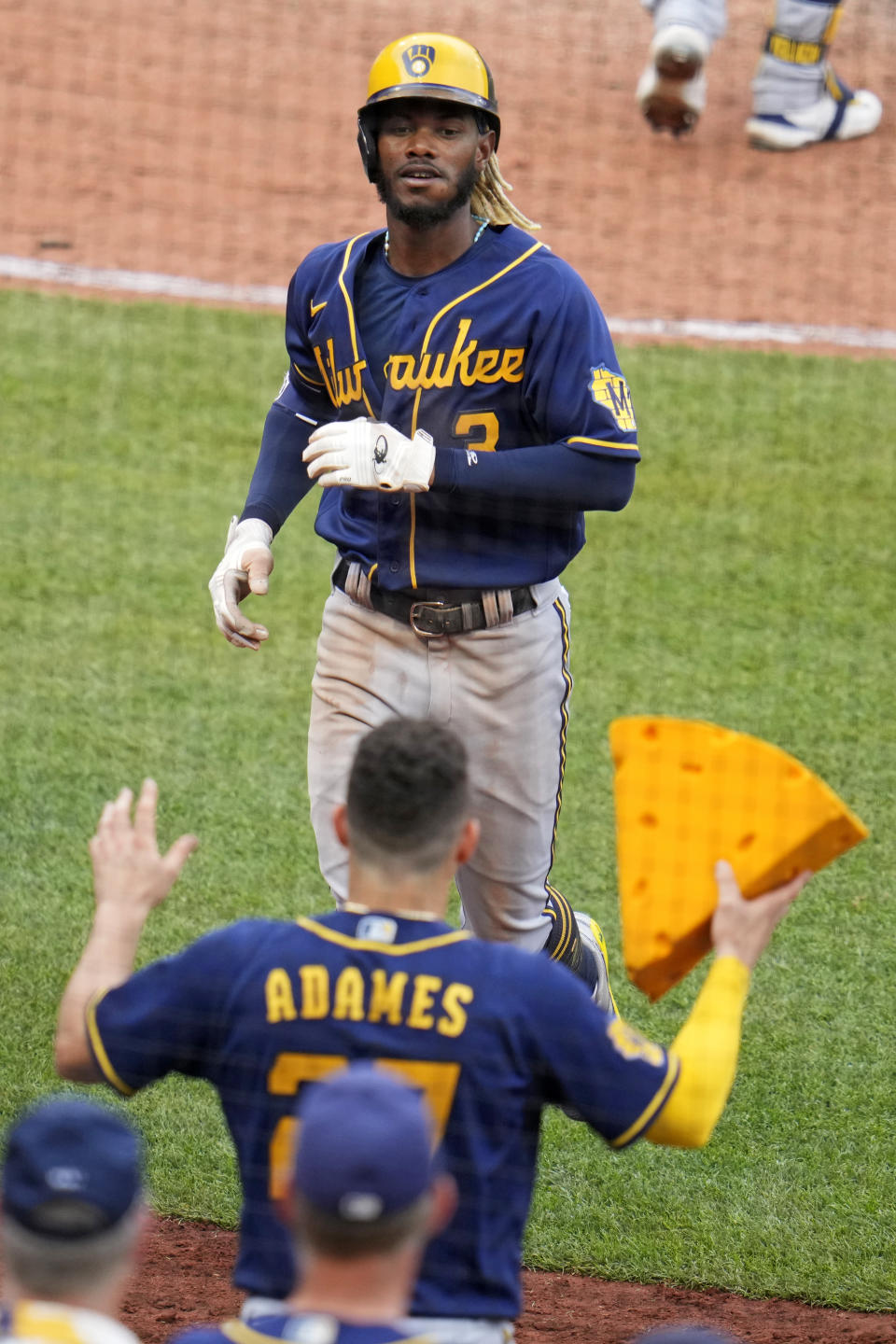 Milwaukee Brewers' Raimel Tapia, top, is greeted at the dugout steps by Willy Adames after hitting a solo home run off Pittsburgh Pirates relief pitcher Roansy Contreras during the seventh inning of a baseball game in Pittsburgh, Saturday, July 1, 2023. (AP Photo/Gene J. Puskar)