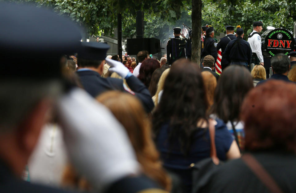 NEW YORK, NY - SEPTEMBER 11: Members of the New York Police Department, Fire Department of New York salute at the beginning of the memorial observances held at the site of the World Trade Center on September 11, 2014 in New York City. This year marks the 13th anniversary of the September 11th terrorist attacks that killed nearly 3,000 people at the World Trade Center, Pentagon and on Flight 93.  (Photo by Chang W. Lee-Pool/Getty Images)