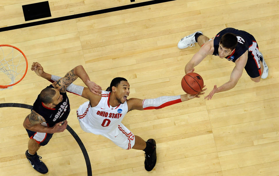 PITTSBURGH, PA - MARCH 17: Jared Sullinger #0 of the Ohio State Buckeyes reaches for a rebound against Robert Sacre #00 (L) and Mike Hart #30 of the Gonzaga Bulldogs during the third round of the 2012 NCAA Men's Basketball Tournament at Consol Energy Center on March 17, 2012 in Pittsburgh, Pennsylvania. (Photo by Gregory Shamus/Getty Images)