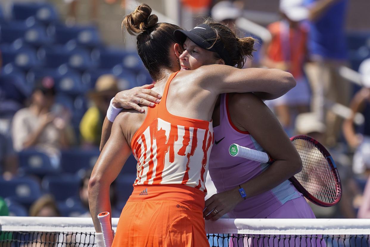 Maria Sakkari, of Greece, left, hugs Tatjana Maria, of Germany, after winning the first round of the U.S. Open tennis championships, Monday, Aug. 29, 2022, in New York.