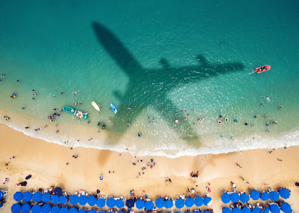 shadow of plane over tropical beach