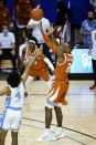 Texas guard Matt Coleman III (2) shoots for the winning basket over North Carolina guard R.J. Davis (4) in the second half an NCAA college basketball game for the championship of the Maui Invitational, Wednesday, Dec. 2, 2020, in Asheville, N.C. Texas won 69-67. Coleman was awarded the MVP. (AP Photo/Kathy Kmonicek)