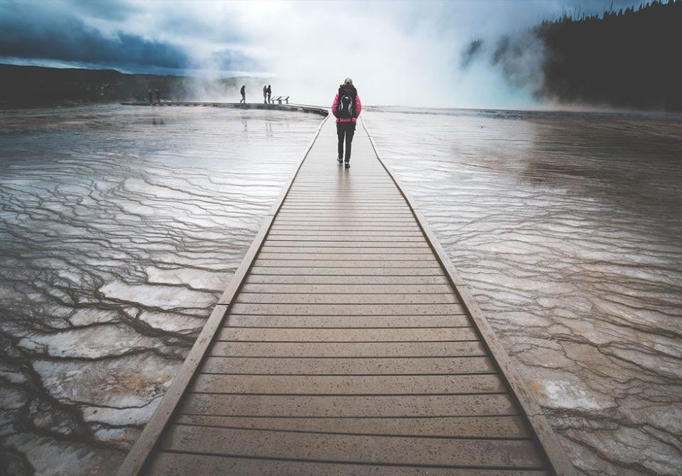 <p>Visitors walking over the mineral-rich pools of Yellowstone National Park // May 2016</p>