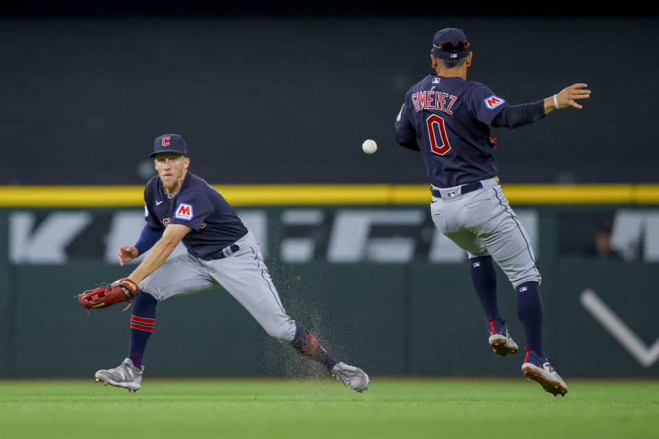 Cleveland Guardians' Myles Straw, left, and Andres Gimenez, right, react after a fly ball dropped for a single during the third inning of a baseball game against the Texas Rangers, Sunday, July 16, 2023, in Arlington, Texas. (AP Photo/Gareth Patterson)