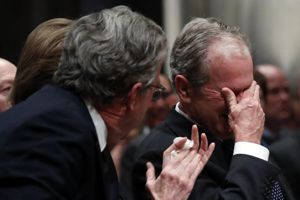 Former President George W. Bush, right, cries after speaking during the state funeral for his father.