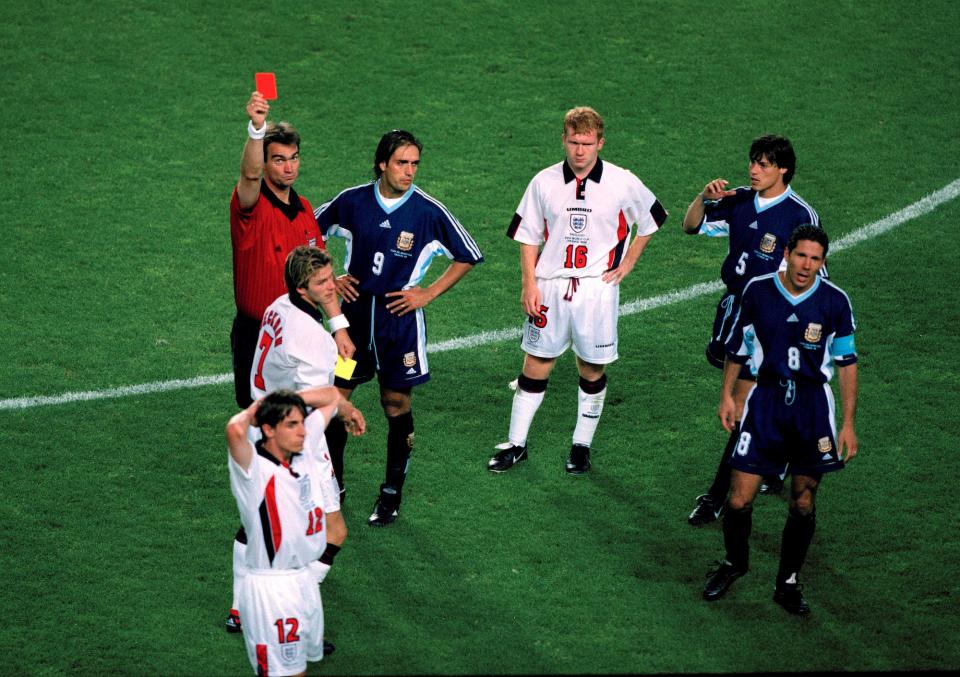 England v Argentina - Referee Kim Milton Nielsen shows the red card to David Beckham as Paul Scholes (16) looks accusingly at Argentinean captain Diego Simeone (8) who was involved in the incident - Gary Neville (12) Gabriel Batistuta (9) and Matias Almeyda (5).