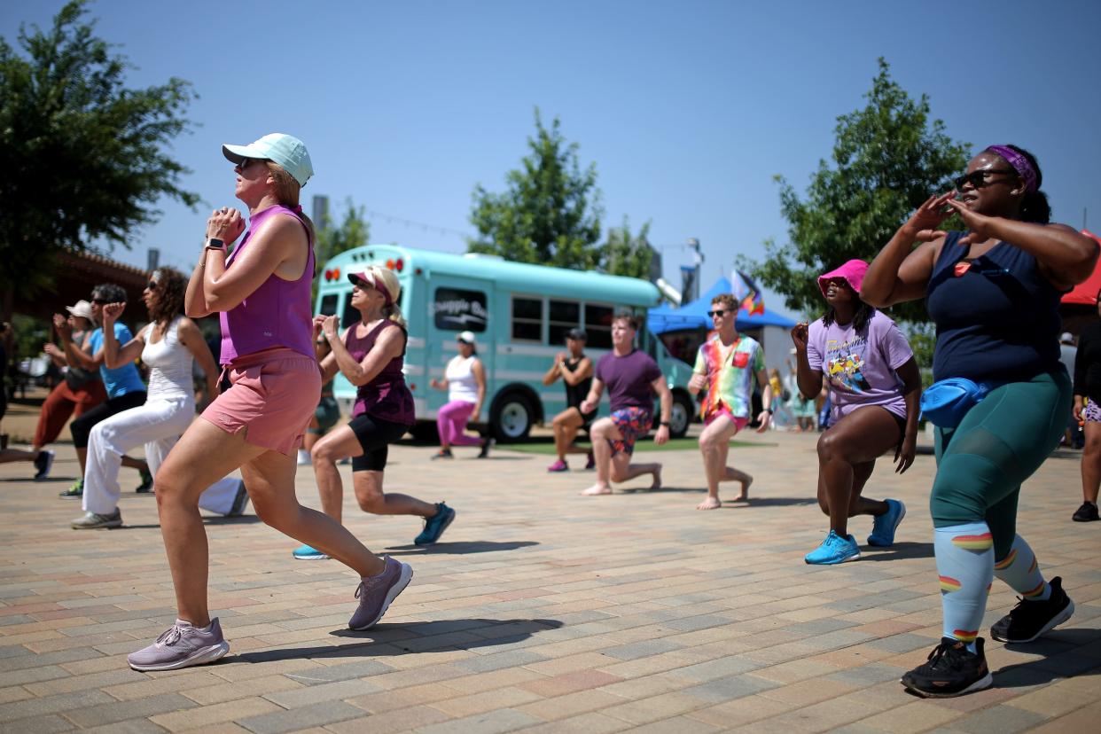 People participate in a YMCA Zumba class June 24 during the OKC Pride Alliance's Pridefest at Scissortail Park in Oklahoma City.