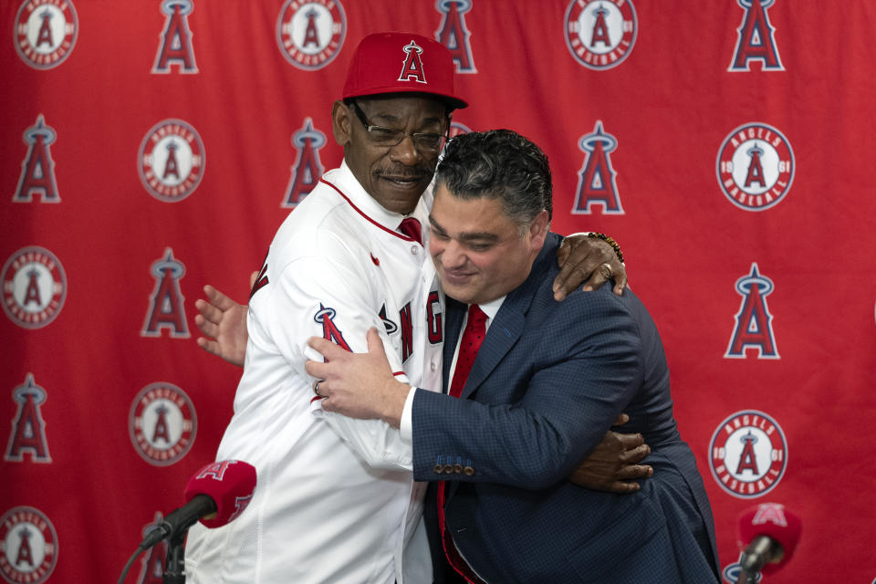 Ron Washington, left, the new manager of the Los Angeles Angels, and general manager Perry Minasian hug during a news conference Wednesday, Nov. 15, 2023, in Anaheim, Calif. (AP Photo/Jae C. Hong)