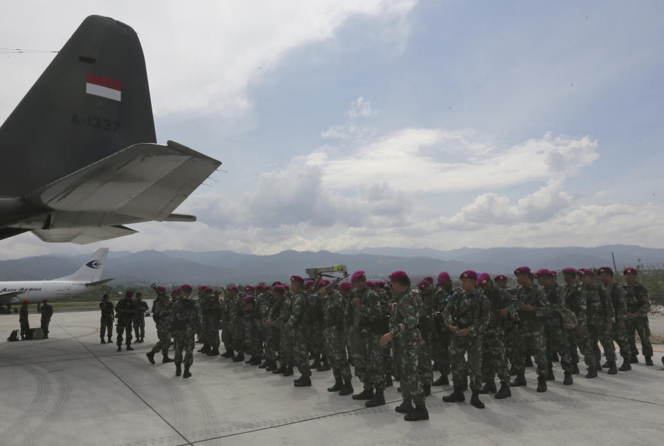 Indonesian Marines arrive to help deliver relief aid relief at the Mutiara Sis Al-Jufri airport in Palu, Central Sulawesi Indonesia, Thursday, Oct. 4, 2018. Life is on hold for thousands living in tents and shelters in the Indonesian city hit by a powerful earthquake and tsunami, unsure when they'll be able to rebuild and spending hours each day often futilely trying to secure necessities such as fuel for generators. (AP Photo/Tatan Syuflana)