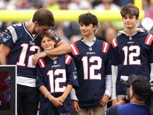 <p>Maddie Meyer/Getty</p> Tom Brady kisses his daughter, Vivian, while his sons, Benjamin and Jack, look on during a ceremony honoring Brady at halftime of New England's game against the Philadelphia Eagles in Foxborough, Massachusetts on September 10, 2023.