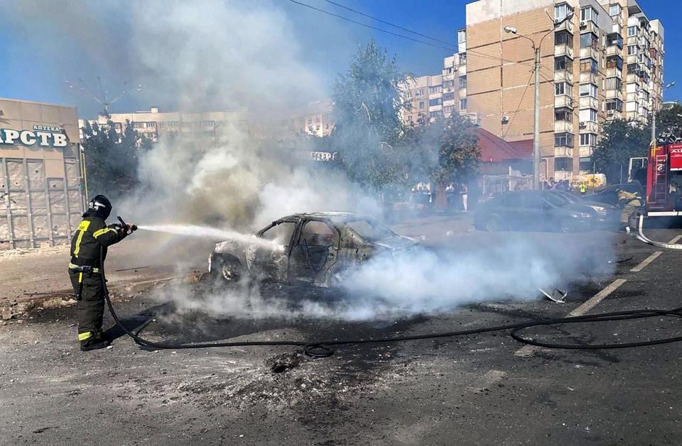 PHOTO: This undated handout photograph released on September 1, 2024, on the official Telegram account of the Belgorod region governor Vyacheslav Gladkov, shows a firefighter extinguishing a car after a recent shelling by a Ukrainian strike in Belgorod. (Vyacheslav Gladkov/handout via AFP via Getty Images)