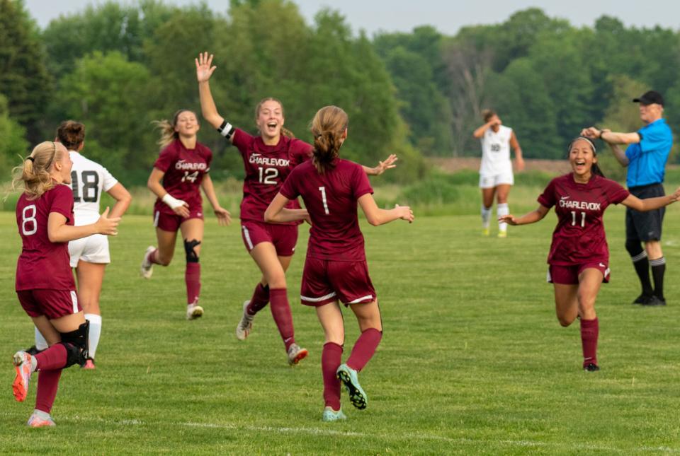 Charlevoix players rush in to celebrate with teammate Blaise Sytsma-Reed (1) after she scored the lone goal of the game against Glen Lake to advance the Rayders to a D4 district final.