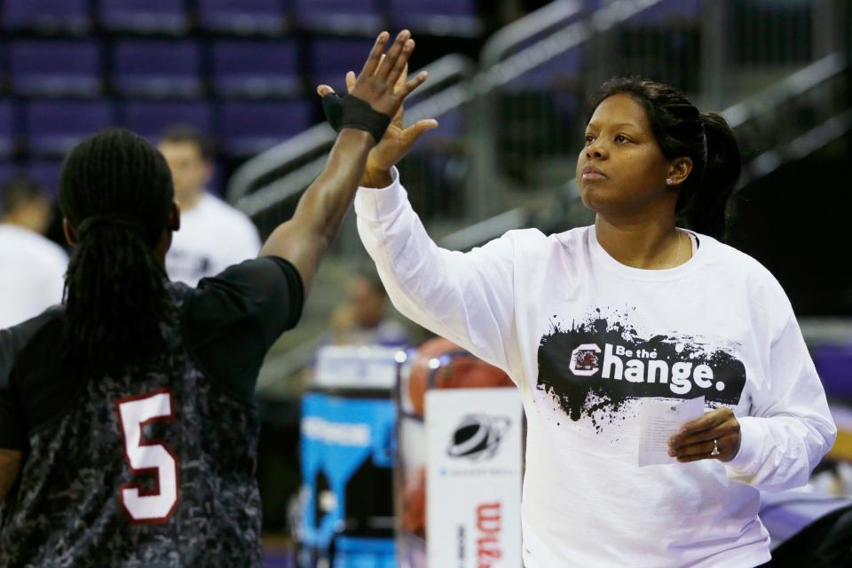 South Carolina assistant coach Nikki McCray-Penson high-fives South Carolina guard Khadijah Sessions during practice at the NCAA women's college basketball tournament in Seattle on March 22, 2014. Sessions is now entering her first season as an assistant coach at South Carolina, carrying on the legacy of her late coach. (AP Photo/Ted S. Warren, File)