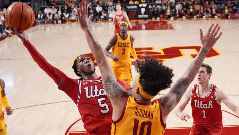 Utah guard Deivon Smith, left, shoots as Southern California forward DJ Rodman defends during the first half of an NCAA college basketball game Thursday, Feb. 15, 2024, in Los Angeles. 