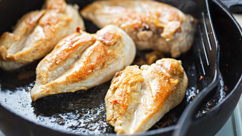 chicken cooking in pan