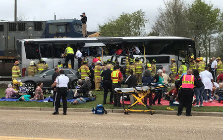 Biloxi firefighters tend to injured passengers escaping the wreckage after a train travelling from Austin, Texas, collided with a charter bus in Biloxi, Mississippi, U.S., March 7, 2017. REUTERS/John Fitzhugh/Biloxi SunHerald