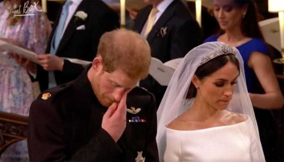 Prince Harry appears to wipe a tear away after a choir plays Guide Me, O Thou Great Redeemer at his wedding to Meghan Markle. Source: Royal Box/ Yahoo UK