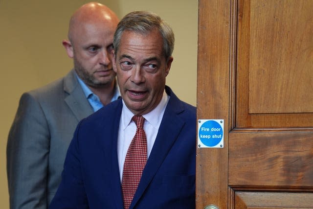 Nigel Farage entering a room to give a press conference