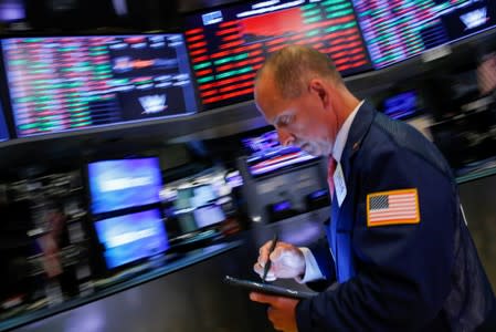 Traders work on the floor at the New York Stock Exchange (NYSE) in New York