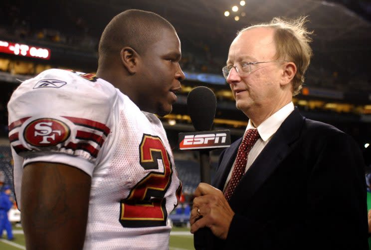 John Clayton talks to 49ers running back Frank Gore after a 2006 game. (AP)