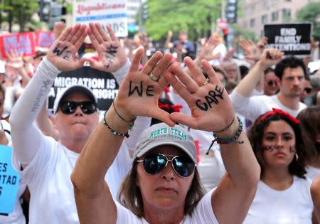Immigration activists rally as part of a march calling for "an end to family detention" and in opposition to the immigration policies of the Trump administration, in Washington, U.S., June 28, 2018. REUTERS/Jonathan Ernst