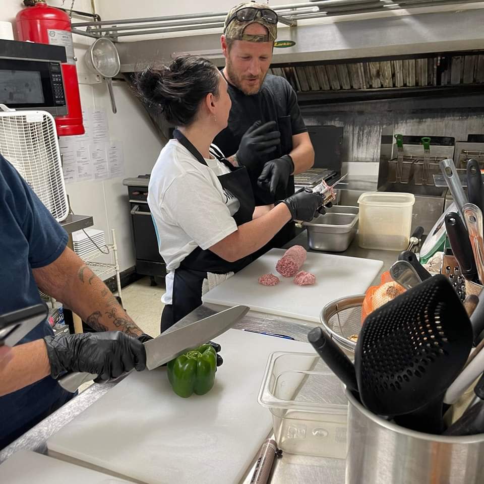 Annalisa Skaggs-Hogue and Brandon Skaggs practice cooking in the kitchen together at Mama’s Mahlzeit.