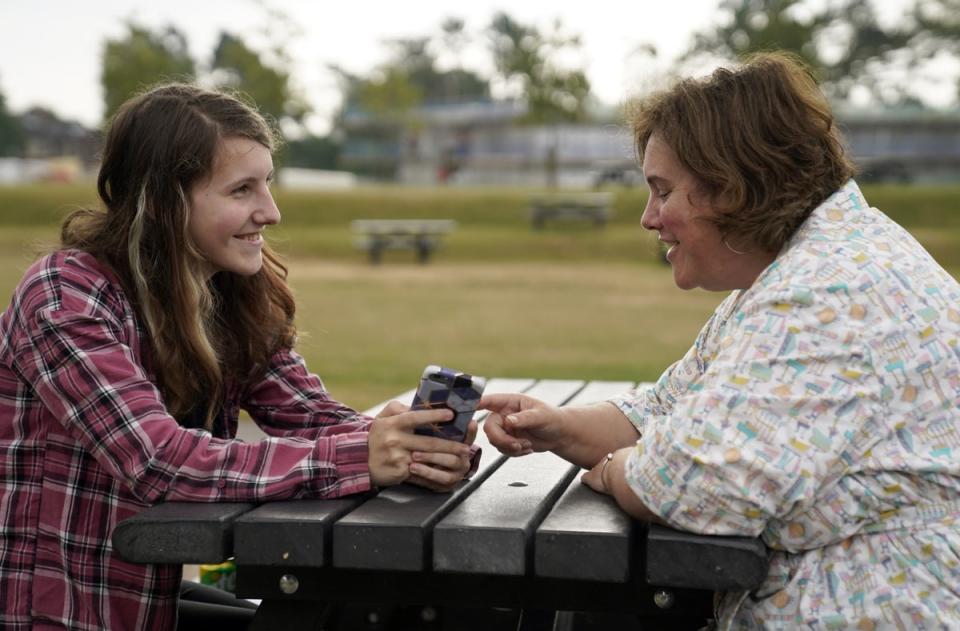 Leyna McQuillin (left) shared the results on her phone with her mother Michelle McQuillin at Peter Symonds College, Winchester (Andrew Matthews/PA) (PA Wire)