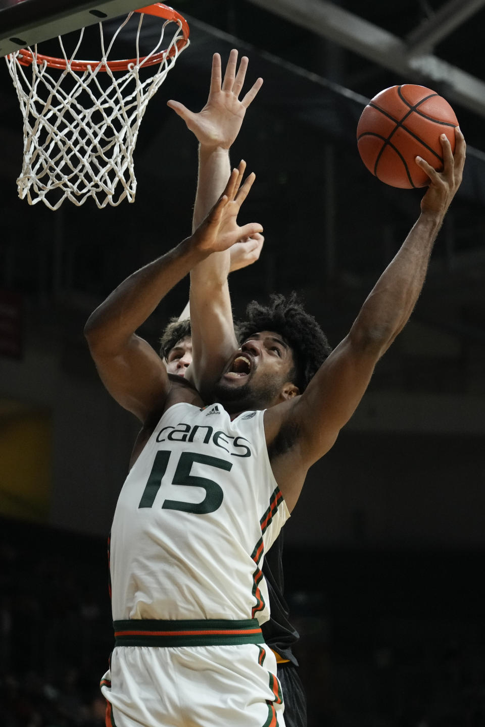 Miami forward Norchad Omier (15) jumps for the basket defended by La Salle forward Rokas Jocius (35) during the second half of an NCAA college basketball game, Saturday, Dec. 16, 2023, in Coral Gables, Fla. Miami defeated La Salle 84-77. (AP Photo/Rebecca Blackwell)