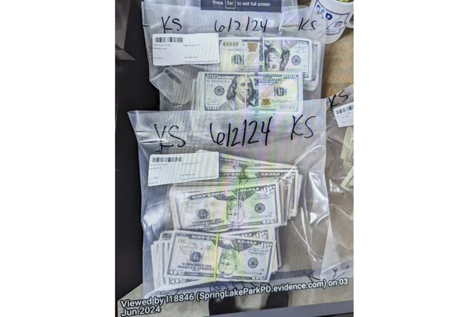 FILE - This image provided by the U.S. Attorney's Office for Minnesota, shows cash from a bag that was left at the home of a juror in a massive fraud case, June 2, 2024, outside Minneapolis, Minn. (U.S. Attorney's Office for Minnesota via AP, File)