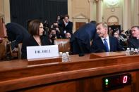 Fiona Hill and David Holmes take their seats before a House Intelligence Committee hearing as part of the impeachment inquiry into U.S. President Donald Trump on Capitol Hill in Washington