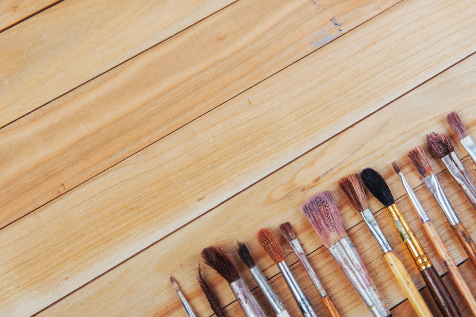 Various artist paintbrushes on a table.