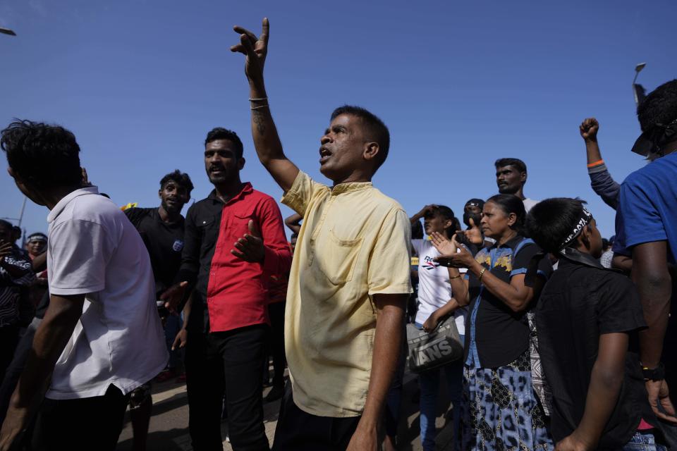 Protesters dance shouting slogans against president Gotabaya Rajapaksa outside his office in Colombo, Sri Lanka, Wednesday, July 13, 2022. The president of Sri Lanka fled the country early Wednesday, slipping away in the middle of the night only hours before he was to step down amid a devastating economic crisis that has triggered severe shortages of food and fuel. (AP Photo/Eranga Jayawardena)