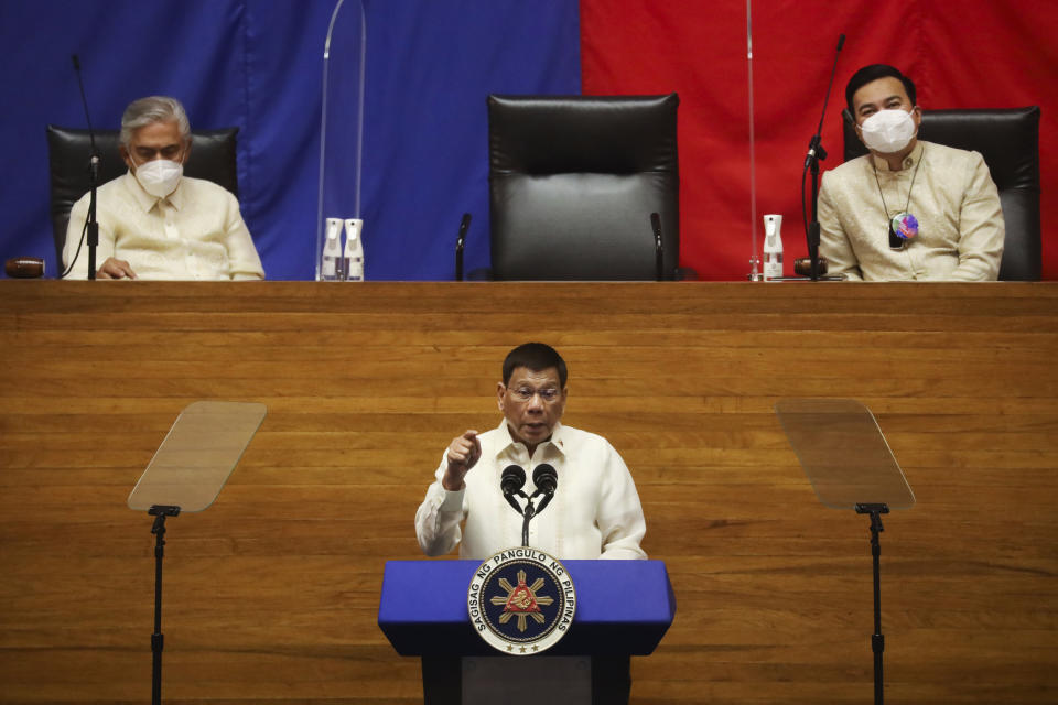 Philippine President Rodrigo Duterte, center, delivers his final State of the Nation Address as Senate President Vicente Sotto III, left, and House Speaker Lord Allan Velasco listens at the House of Representatives in Quezon City, Philippines on Monday, July 26, 2021. Duterte delivered his final State of the Nation speech Monday before Congress, winding down his six-year term amid a raging pandemic, a battered economy and a legacy overshadowed by a bloody anti-drug crackdown that set off complaints of mass murder before the International Criminal Court. (Lisa Marie David/Pool Photo via AP)