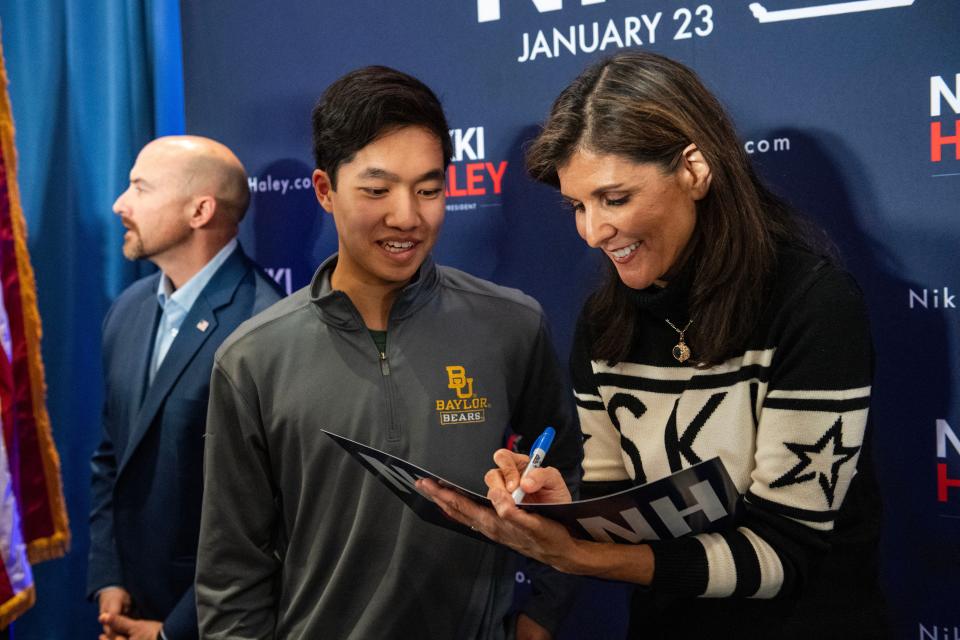 Former UN ambassador and 2024 presidential hopeful Nikki Haley signs for supporters at a town hall campaign event at Hilton Garden Inn in Lebanon, New Hampshire on December 28, 2023.