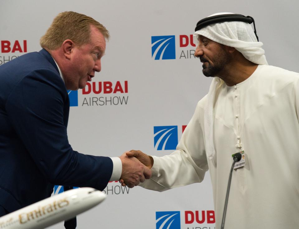 Boeing Commercial Airplanes president and CEO Stanley A. Deal, left, shakes hands with Sheikh Ahmed bin Saeed Al Maktoum, the chairman and CEO of the Dubai-based long-haul carrier Emirates, at the Dubai Airshow in Dubai, United Arab Emirates, Wednesday, Nov. 20, 2019. Dubai's carrier Emirates announced Wednesday a firm order for 30 Boeing 787 Dreamliners in deal valued at $8.8 billion. (AP Photo/Jon Gambrell)