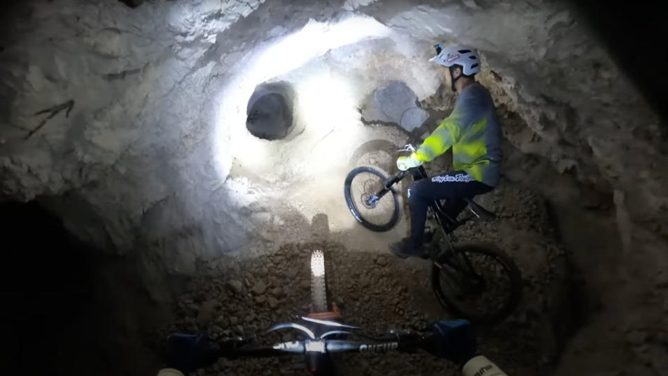  Mountain bikers underground in a mine shaft. 